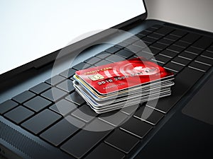 Credit cards standing on laptop computer keyboard. 3D illustration