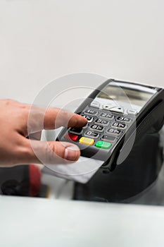 Credit or debit card password payment. Customer hand is entering