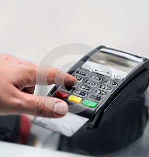 Credit or debit card password payment. Customer hand is entering