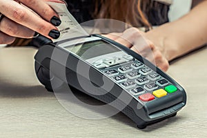 Credit or debit card password payment. Customer hand is entering personal identification number in shop or supermarket