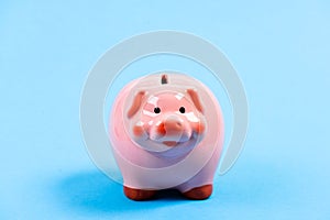 Credit debt. money saving. piggy bank on blue background. planning budget. income management. financial problem