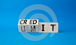 Credit limit symbol. Turned wooden cubes with words credit and limit. Beautiful blue background. Business and Credit limit concept