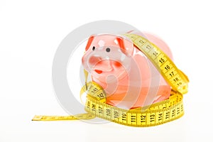 Credit loan debt. Measure costs. Piggy bank and measuring tape. Budget limit concept. Economics and finances. Pig trap