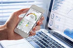 Credit Report with Score rating app on smartphone screen showing creditworthiness of a person for loan and mortgage application photo