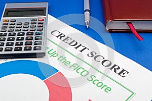 Credit score report with calculator on a blue table