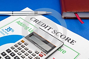 Credit score report with calculator on a blue table