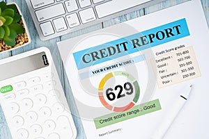 The Credit score report and calculator with computer keyboard on the desk