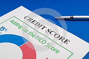 Credit score report and pen on the blue table