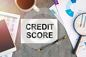 Credit Score is written in a document on the office desk, coffee, diagram and smartfon