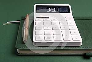 Credit word on calculator over green. Risk assessment concept