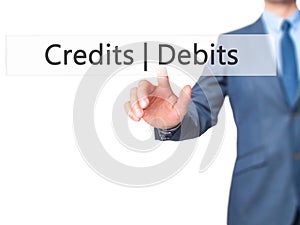 Credits Debits - Businessman hand pressing button on touch scre