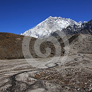 Creek and azure blue sky over Mount Nuptse