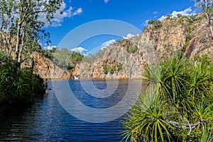 The creek carrying the clear water of Edith Falls Lelyin with the rock wall reflecting in the water, Nitmiluk National Park,