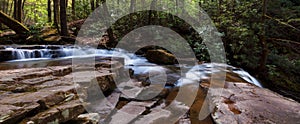 Creek flowing over flat rocks above Laural Run Waterfalls