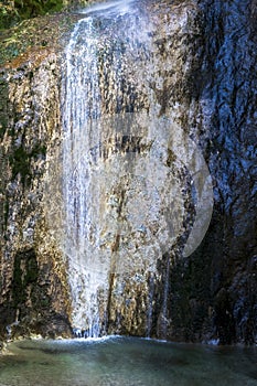 Creek and huge waterfall in mountain at Tolmin in Slovenia