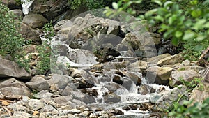 Creek, stream or small and quick mountain river with crystal clear flowing water. Source, spring water. Summer day