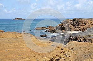 Creek between two cliffs with black sand beach