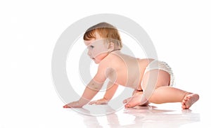 Creeping little boy in diapers in the studio on a white background