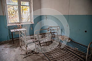 Creepy, abandoned room with beds in the building located in the Chernobyl ghost town
