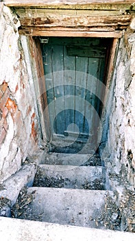 Creepy cellar door leading to basement in an old building