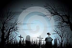 Creepy cemetery Halloween background with tree and tombstone back lit