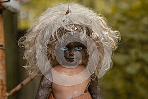 Creepy doll at the backyard of the kindergarten at the abandoned village Kopachi near Chernobyl