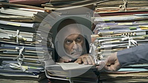 Creepy office clerk overloaded with paperwork photo