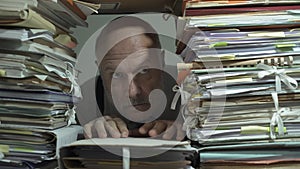 Creepy office clerk overloaded with paperwork photo