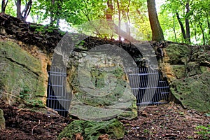 Creepy passage door and grate in a cave