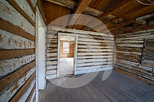 Creepy, vacant spooky interior of an abandoned log cabin in Bannack Ghost Town in Montana