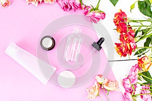 Crema Skincare Cosmetics Essence, Oil on a pink and white desk. Beauty background Mock up photo