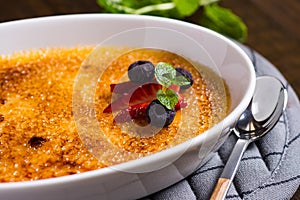 Creme Brulee Dessert with Caramelised Sugar, Strawberry, Blueberry and Fresh Mint Leaves