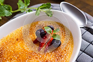 Creme Brulee Dessert with Caramelised Sugar, Strawberry, Blueberry and Fresh Mint Leaves