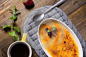 Creme Brulee Dessert with Caramelised Sugar, Strawberry, Blueberry and Fresh Mint Leaves photo