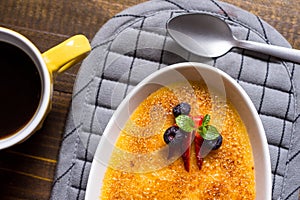 Creme Brulee Dessert with Caramelised Sugar, Strawberry, Blueberry and Fresh Mint Leaves