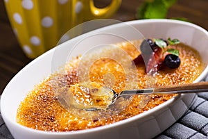 Creme Brulee Dessert with Caramelised Sugar, Strawberry, Blueberry and Fresh Mint Leaves photo