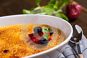 Creme Brulee Dessert with Caramelised Sugar, Strawberry, Blueberry and Fresh Mint Leaves