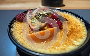 Creme brulee with fruits on restaurant table