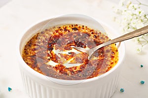 Creme brulee. Traditional French vanilla cream dessert. Burned cream. Broken, cracked crust photo