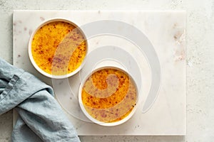 Creme brulee. Traditional French vanilla cream dessert. Burned cream. Top view, copy space photo