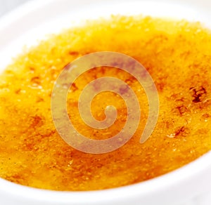Creme Brulee on the wooden Backgrounf, close up. photo