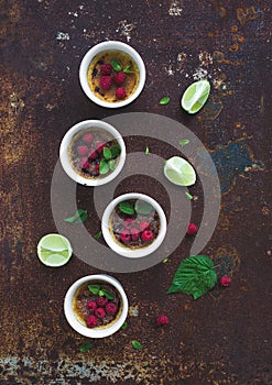 Creme brulees with raspberries and mint in white