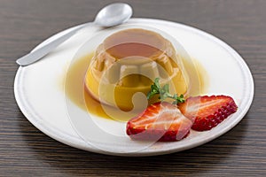 Creme caramel vanilla custard dessert or flan on white dish with