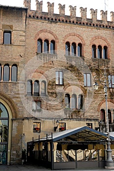 Crenellated facade of an old building in the center of Parma in Italy photo