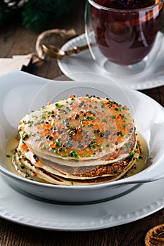 Crep for Christmas and New Year. Christmas pancakes with caviar as New Year. Festive decor of the table for Christmas photo