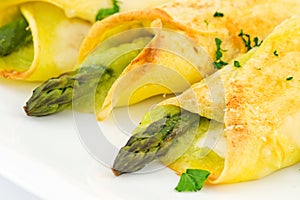 Crepes with asparagus and cream sauce photo