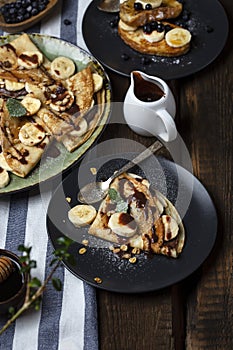Crepes with banana, chocolate-nut sauce and sweet croutons