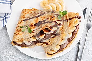 Crepes or blini stuffed with chocolate, banana