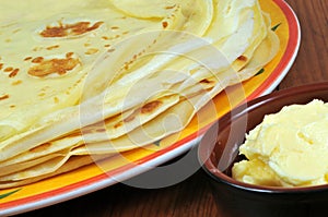 Crepes in close-up with butter in a ramekin