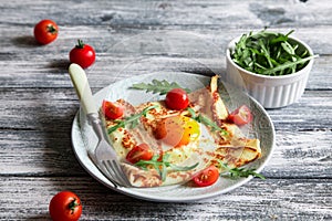 Crepes with eggs, cheese, arugula leaves and tomatoes. Galette complete. Traditional dish galette sarrasin